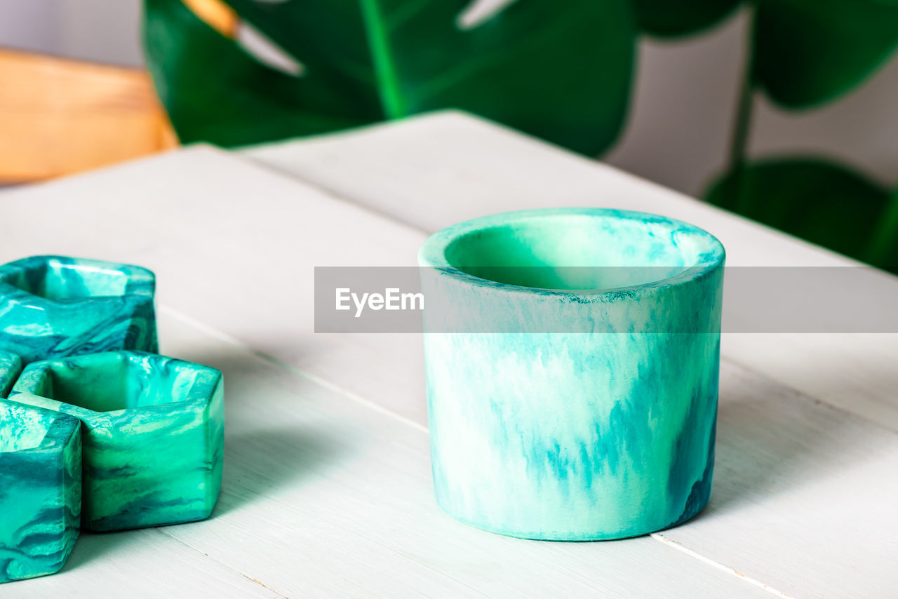 HIGH ANGLE VIEW OF DRINK IN GLASS ON TABLE AGAINST BLUE BACKGROUND