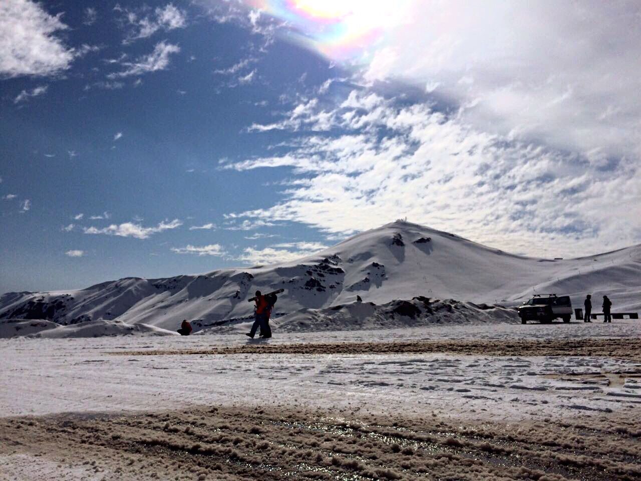 MAN ON MOUNTAIN AGAINST SKY