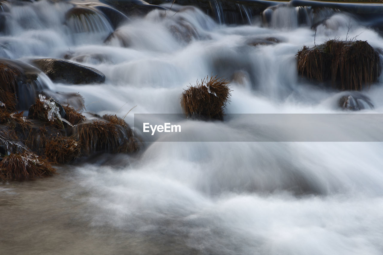 PANORAMIC VIEW OF WATERFALL IN FOREST