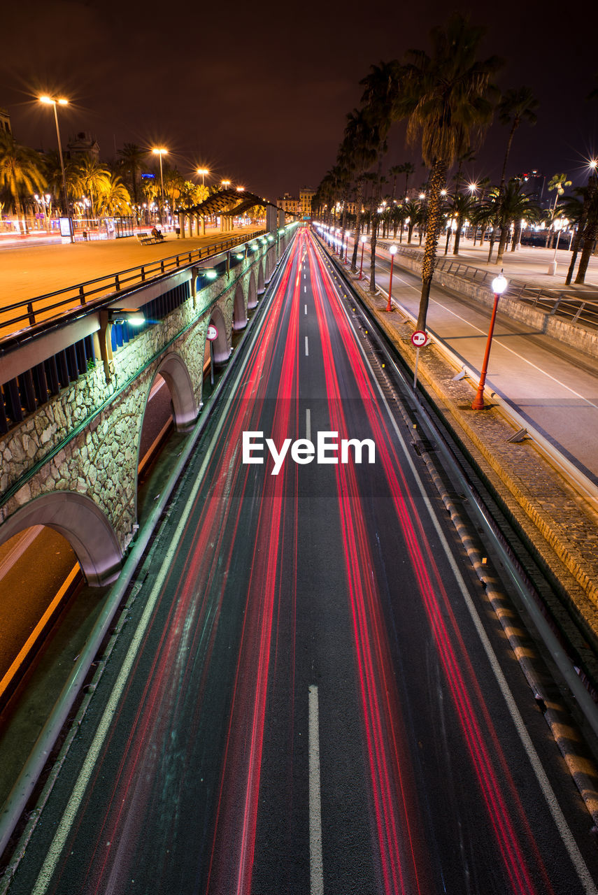 High angle view of light trails on road at night