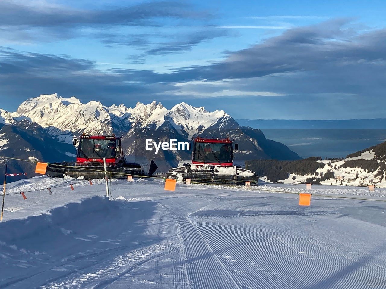 snow, winter, cold temperature, mountain, mountain range, landscape, scenics - nature, environment, sky, piste, nature, beauty in nature, transportation, travel, snowcapped mountain, travel destinations, architecture, cloud, mode of transportation, built structure, city, road, no people, building exterior, outdoors, day, winter sports, tourism, frozen, land, ice, ski, vacation, mountain peak, building