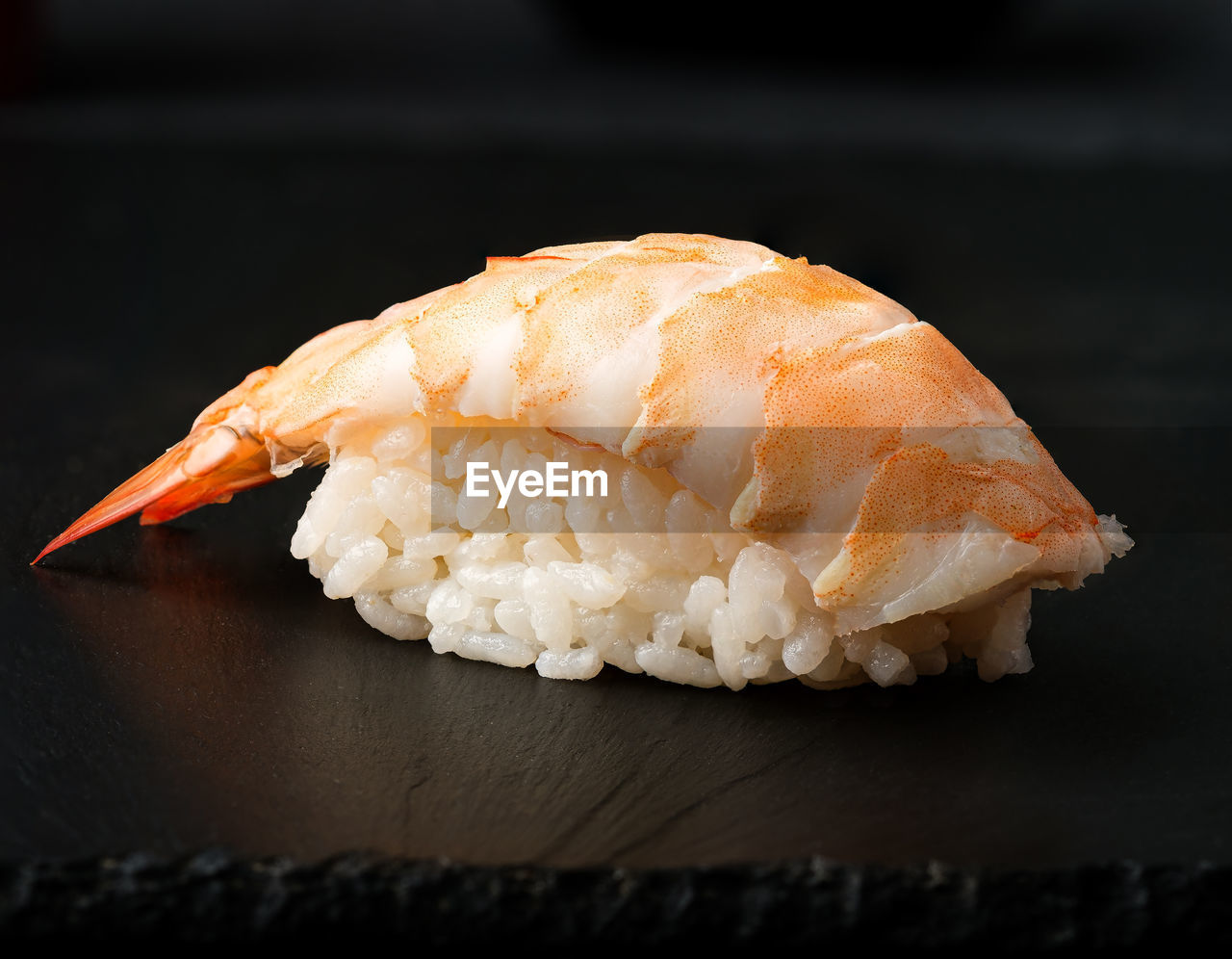 Shrimp sushi on  a black background