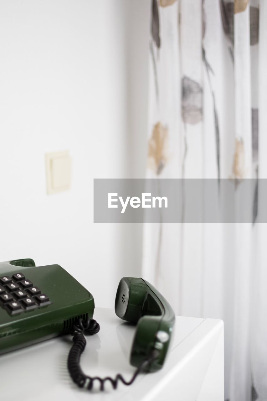 Close-up of landline phone on table