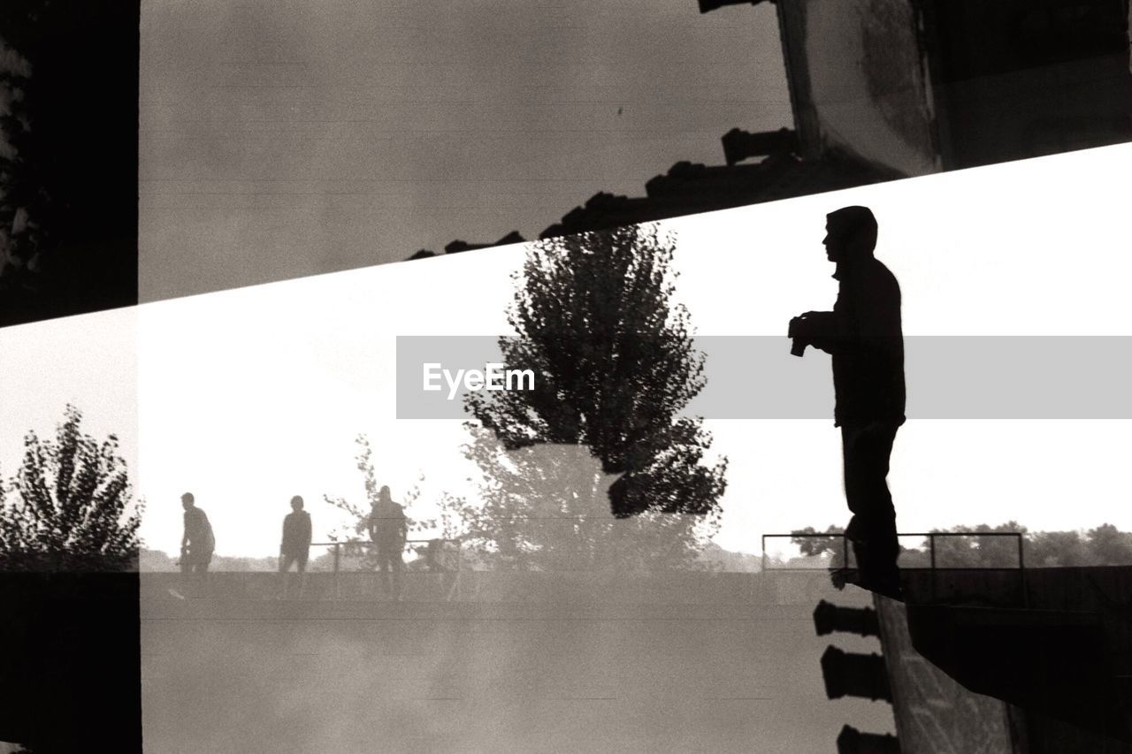 MAN STANDING ON BRIDGE