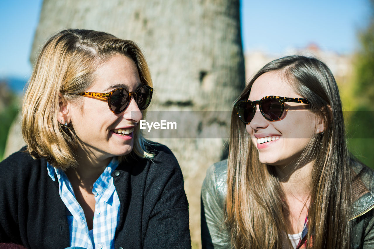 Portrait of smiling young friends wearing sunglasses