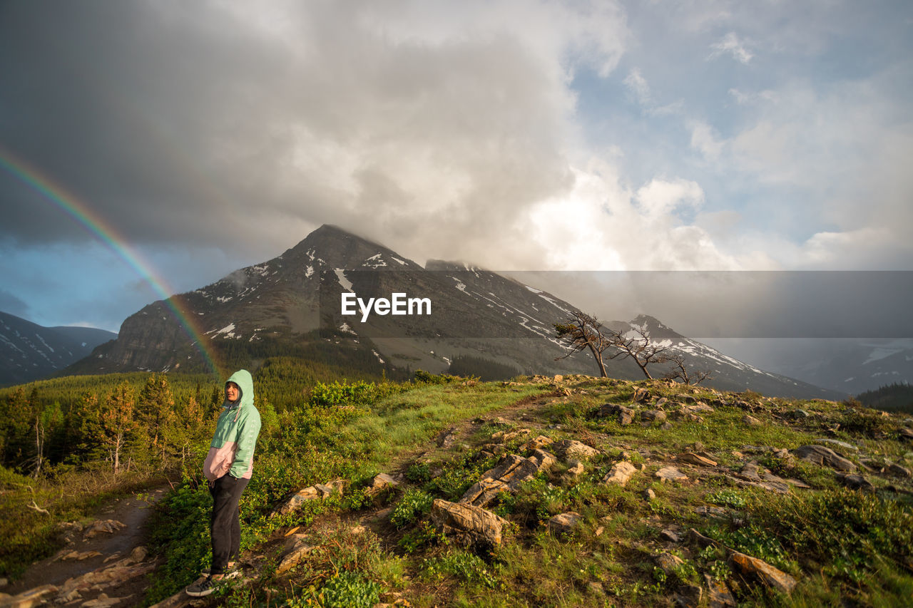 Man standing on mountain against sky