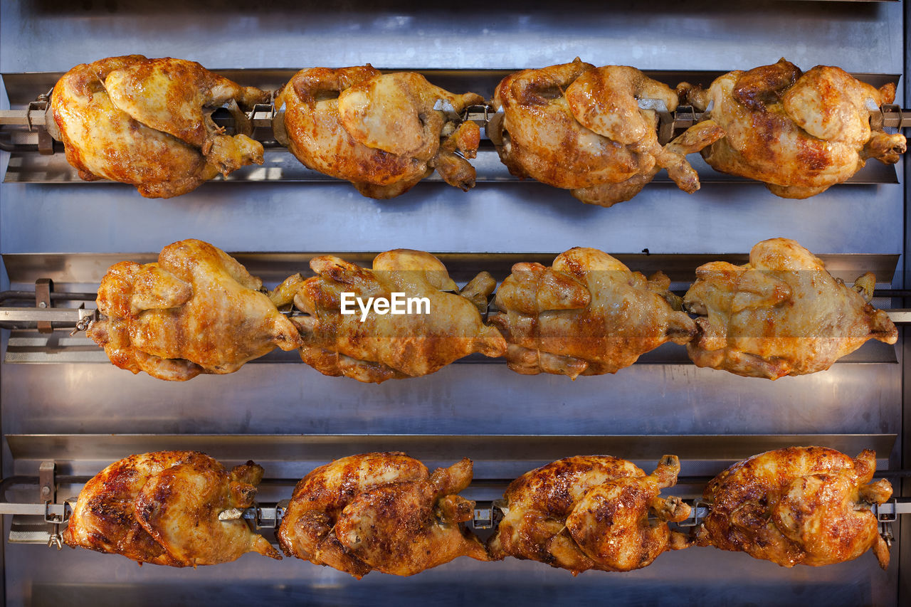 High angle view of roasted chicken on barbecue grill