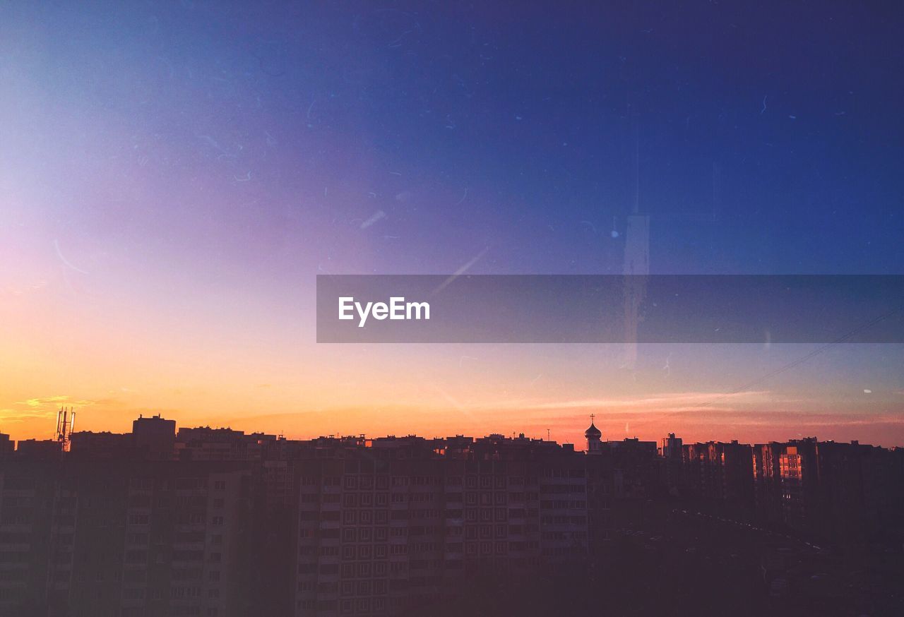 SILHOUETTE CITYSCAPE AGAINST SKY DURING SUNSET