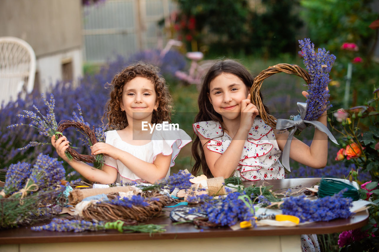 portrait of happy friends sitting on table