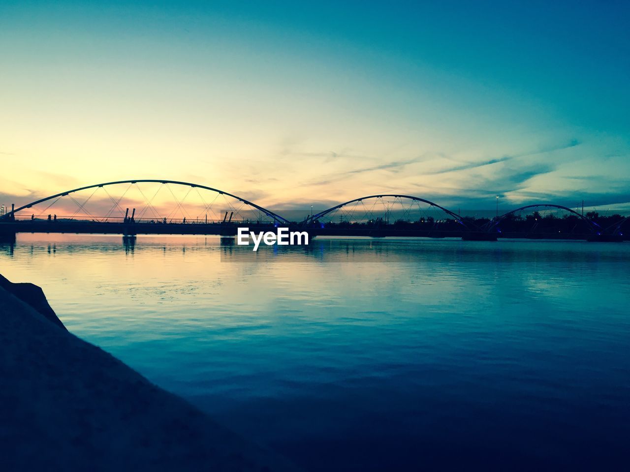 SCENIC VIEW OF BRIDGE AGAINST SKY AT SUNSET
