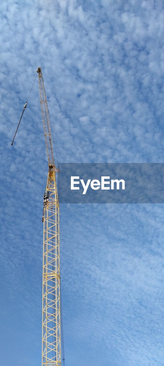 low angle view of crane against cloudy sky