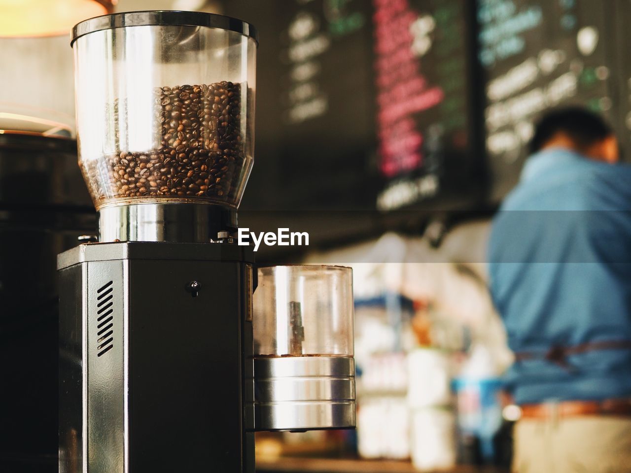 Coffee beans in espresso maker at cafe