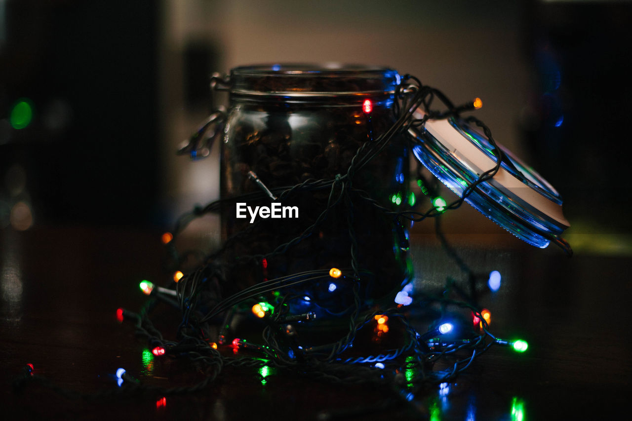 Close-up of illuminated string light on jar during christmas