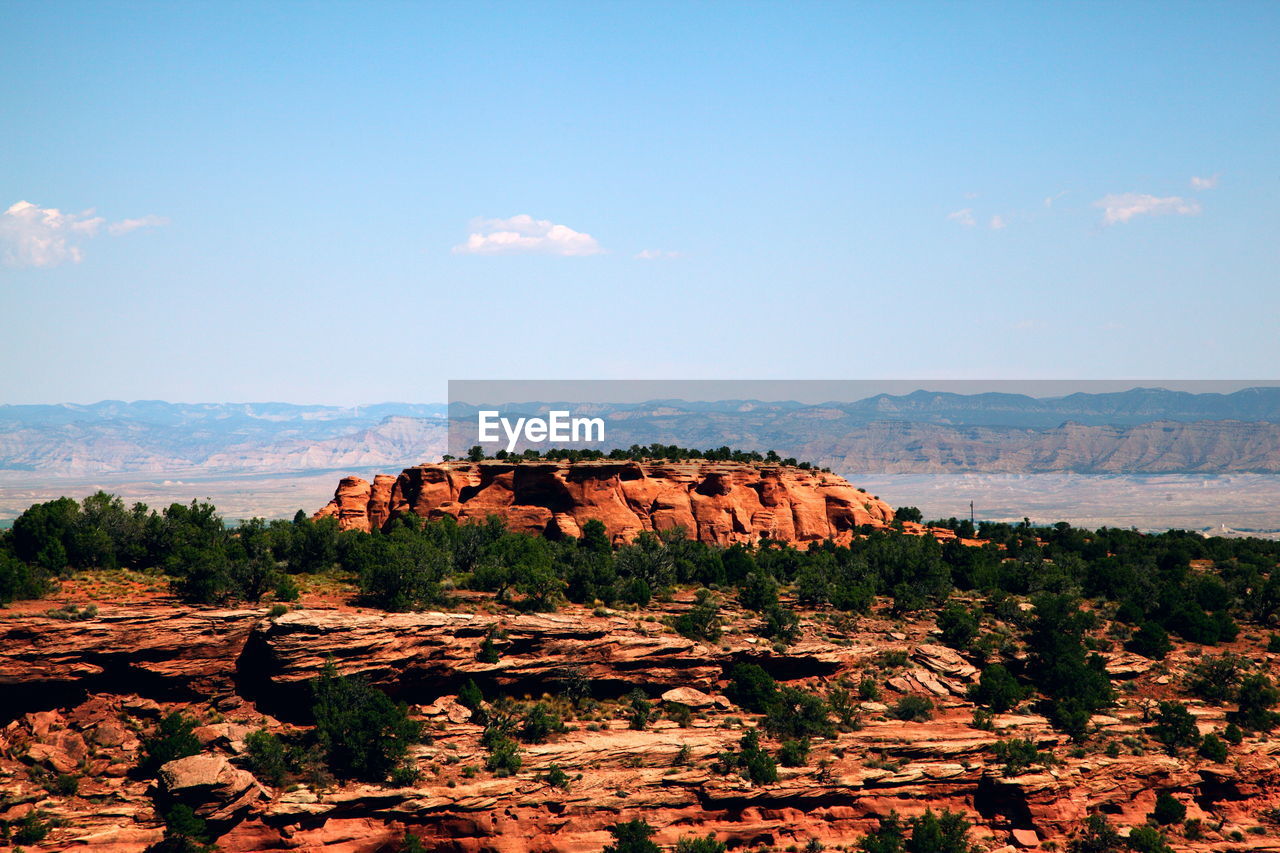 Rock formations on landscape against sky