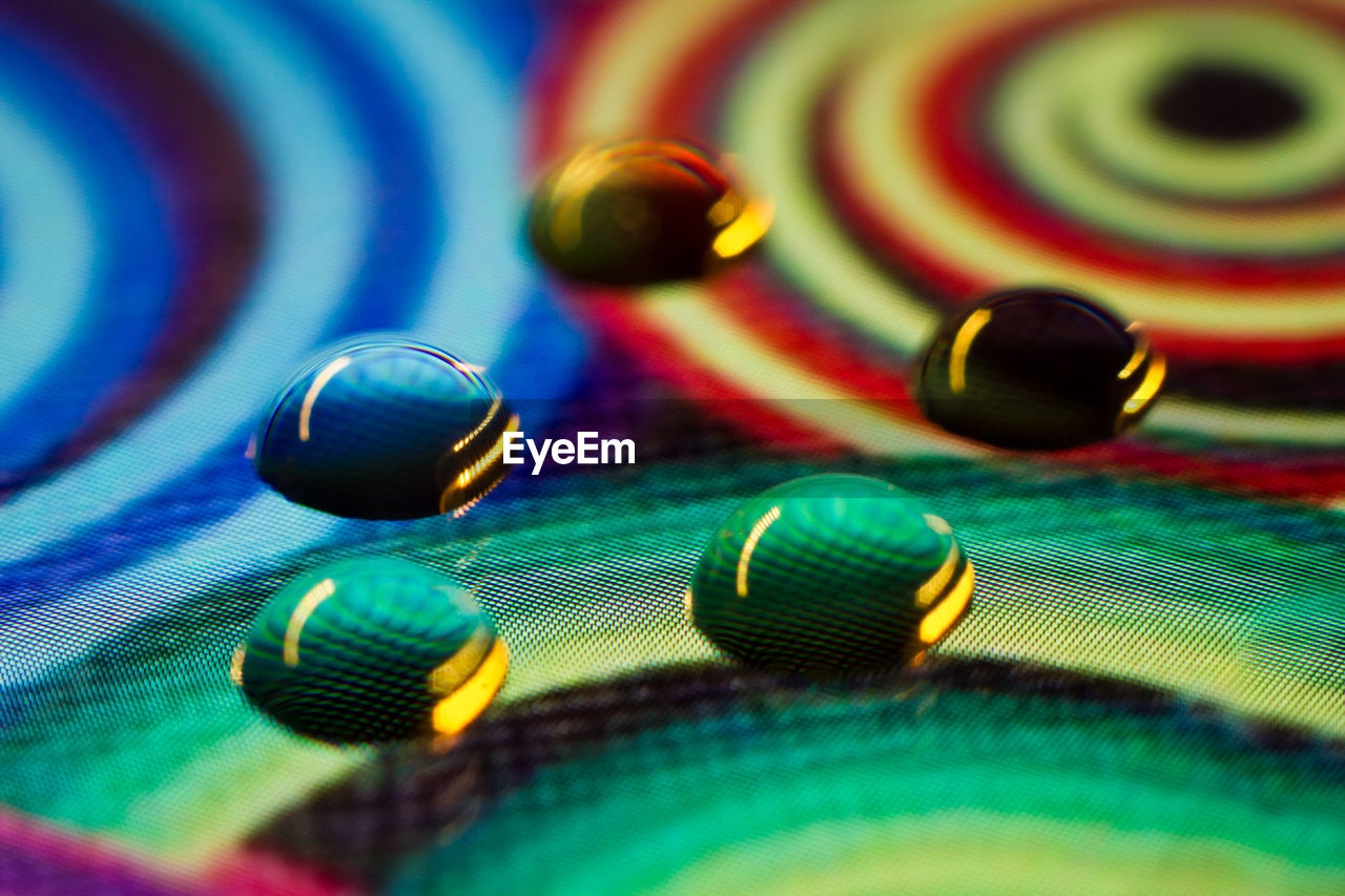 Close-up of water drops on colorful display screen