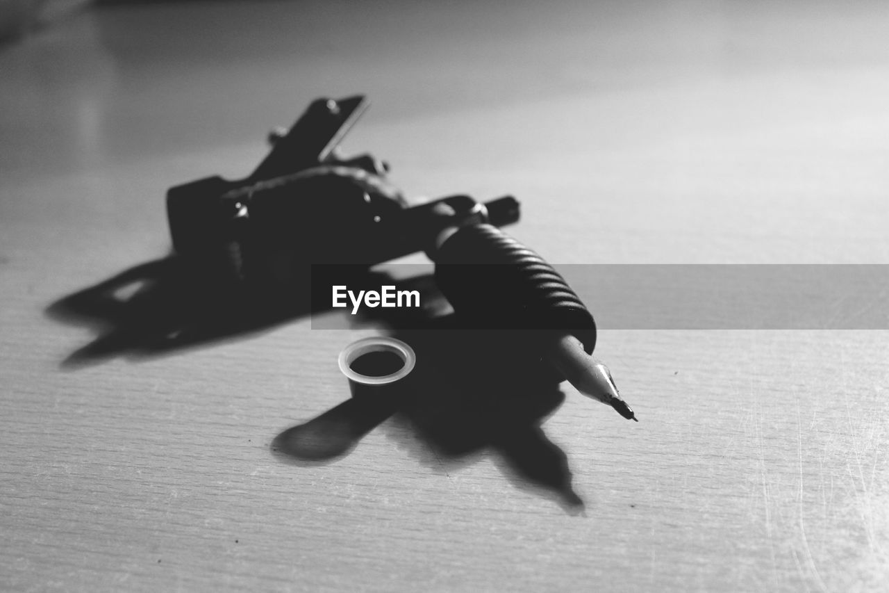 Close-up tattoo gun on table