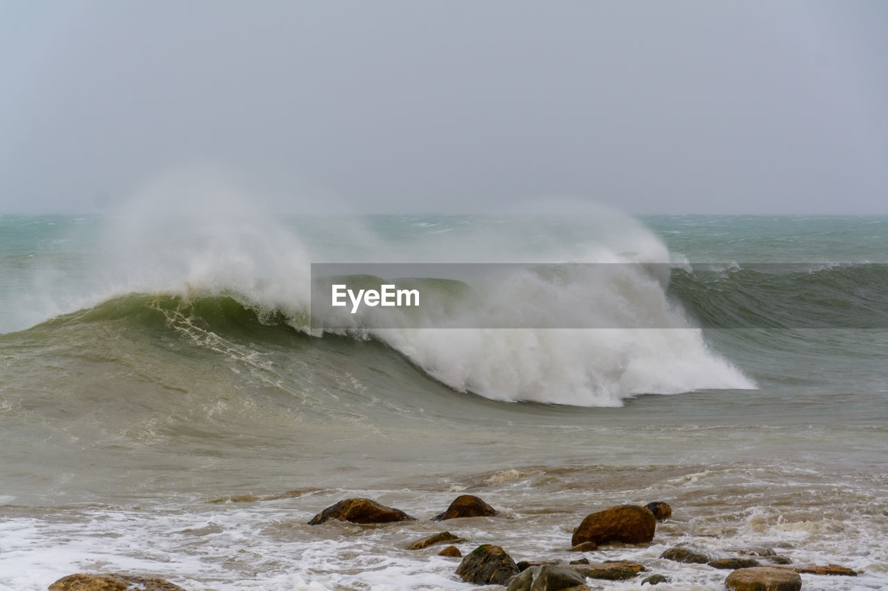 WAVES BREAKING ON SHORE