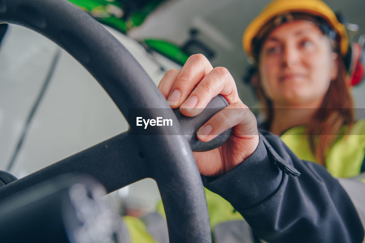 Woman driving construction vehicle