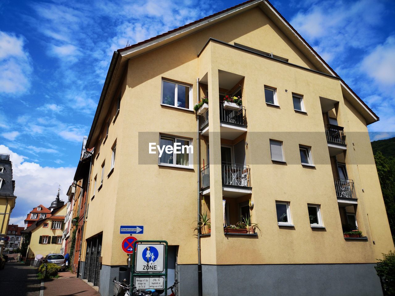 LOW ANGLE VIEW OF YELLOW BUILDING AGAINST SKY