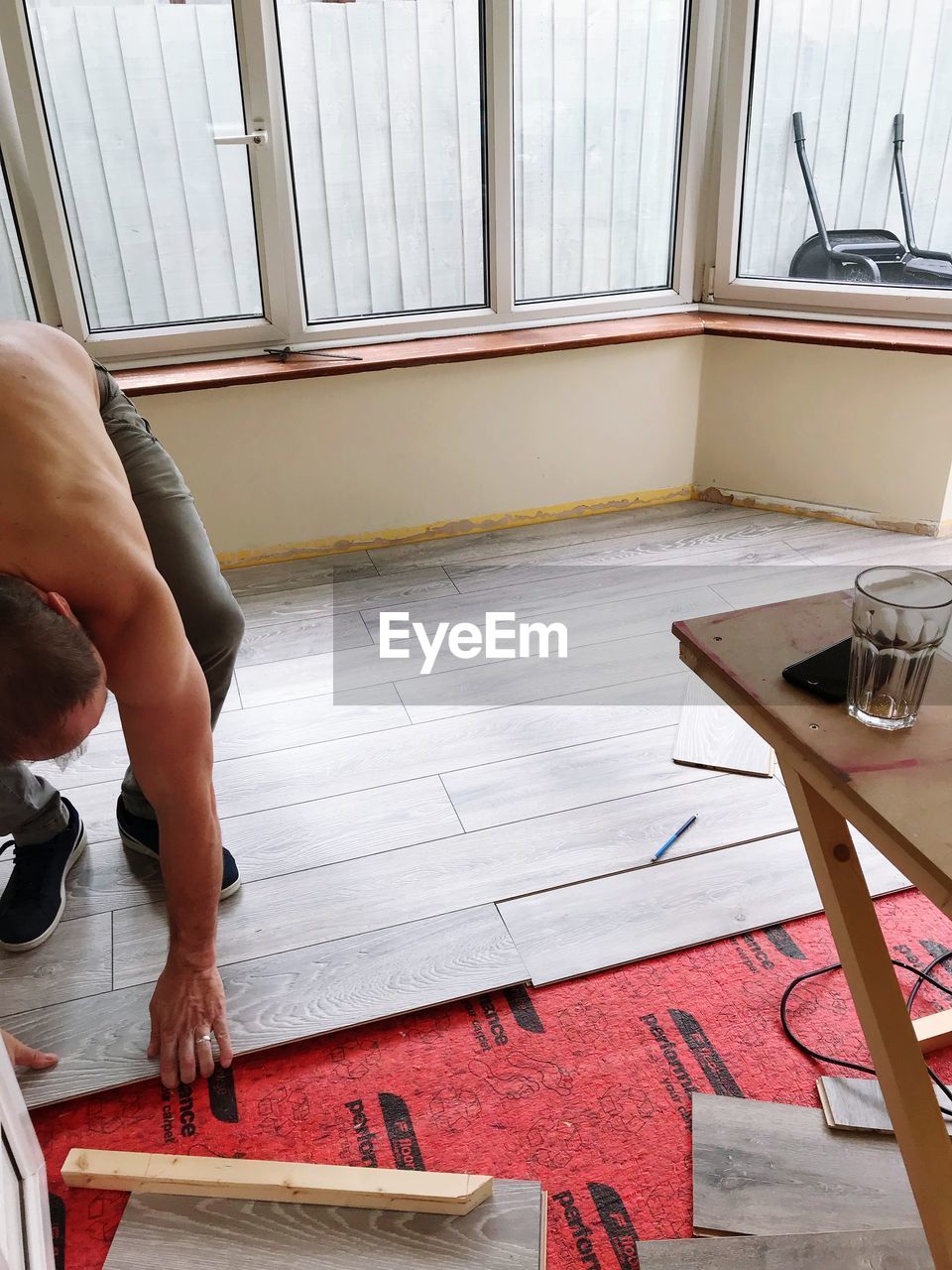 LOW SECTION OF MAN RELAXING ON TABLE