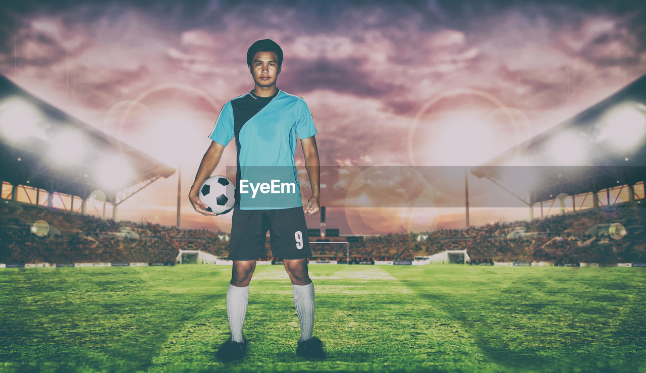 Digital composite image of soccer player while standing on field against sky