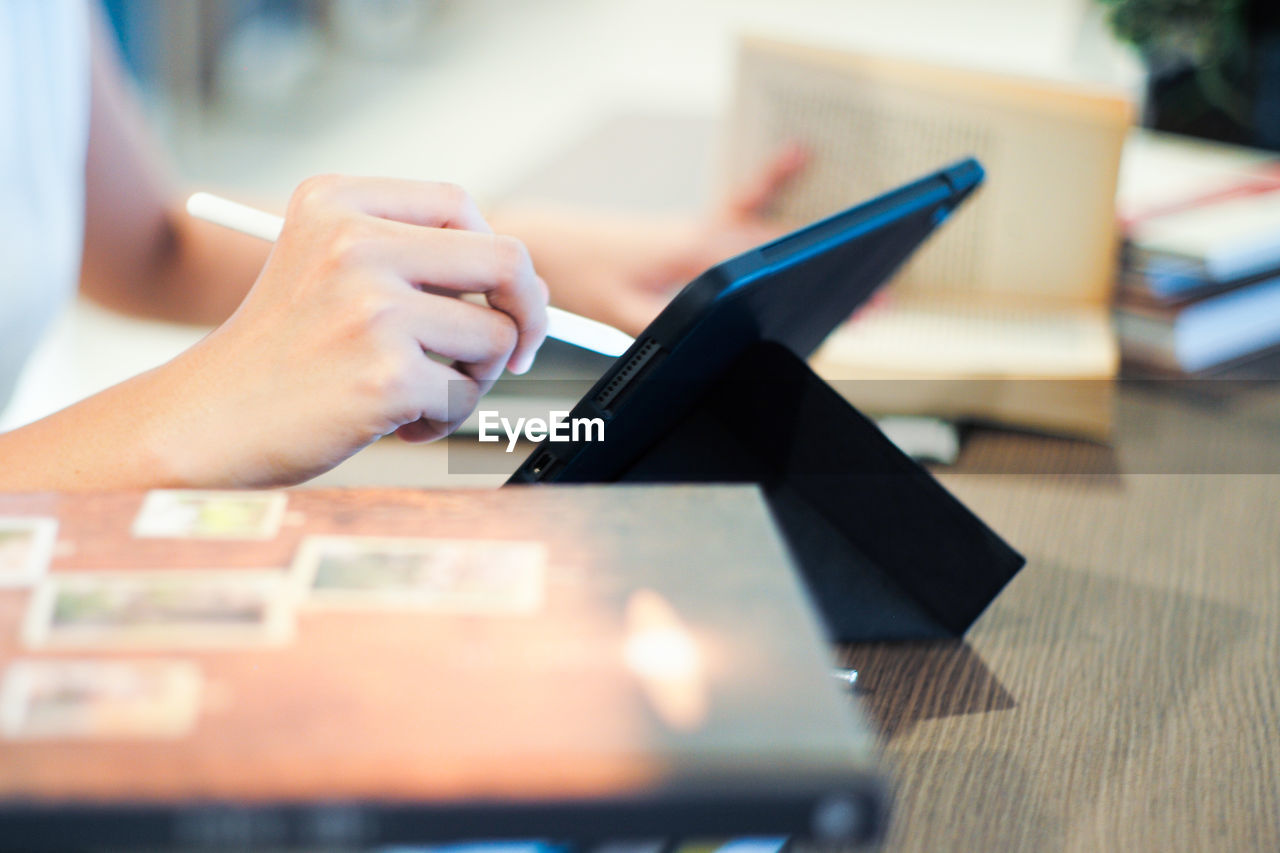 one person, writing, adult, hand, indoors, technology, women, selective focus, wireless technology, table, business, young adult, communication, business finance and industry, close-up, computer, female, working, desk, businesswoman, occupation