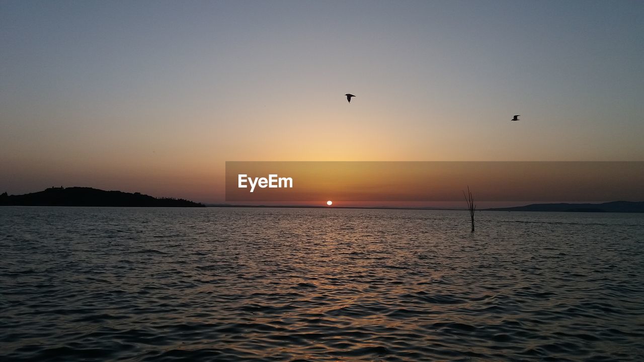 SCENIC VIEW OF SEA DURING SUNSET