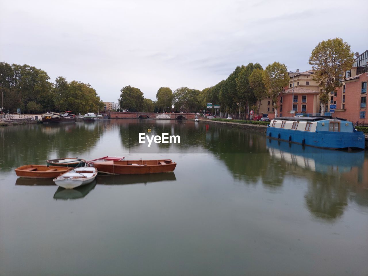 water, nautical vessel, reflection, transportation, river, boat, vehicle, mode of transportation, architecture, nature, sky, waterway, tree, boating, body of water, built structure, building exterior, watercraft, moored, travel destinations, travel, tranquility, building, plant, no people, cloud, day, house, outdoors, tourism, ship, beauty in nature, trip, environment, city, holiday, vacation, tranquil scene, channel, scenics - nature, landscape