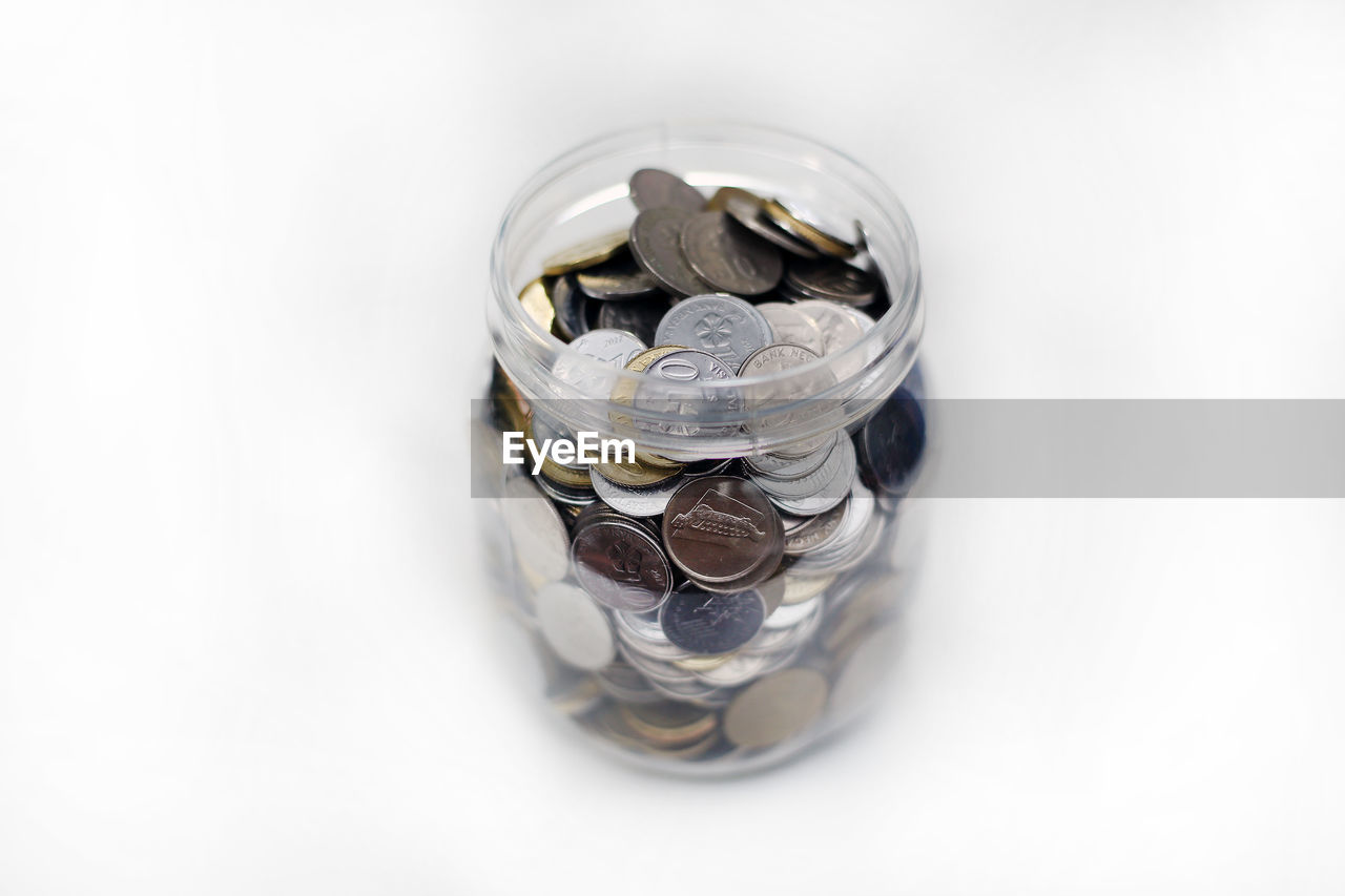 HIGH ANGLE VIEW OF COINS IN JAR