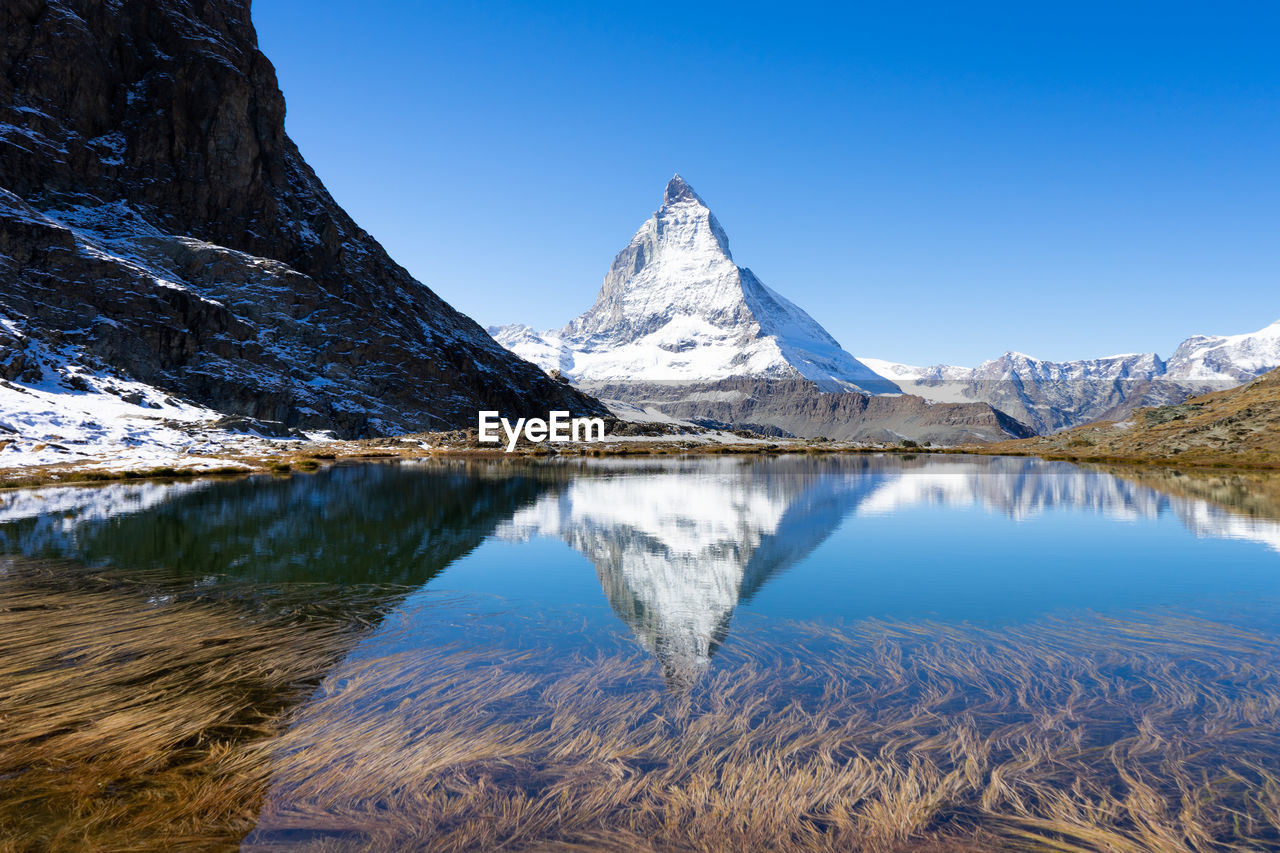 Scenic view of snowcapped matterhorn against sky during winter