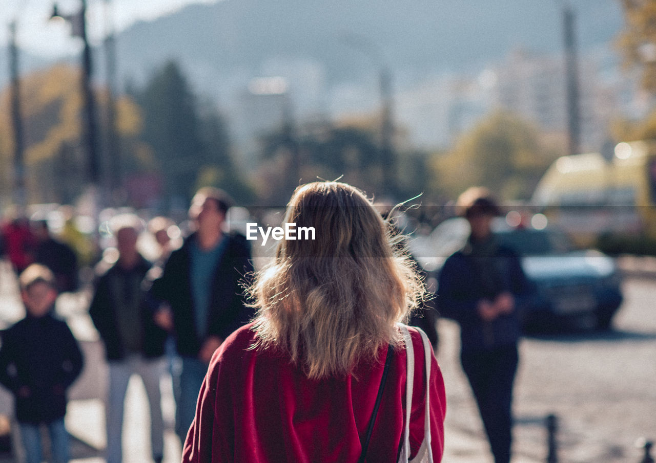 Rear view of woman standing on street