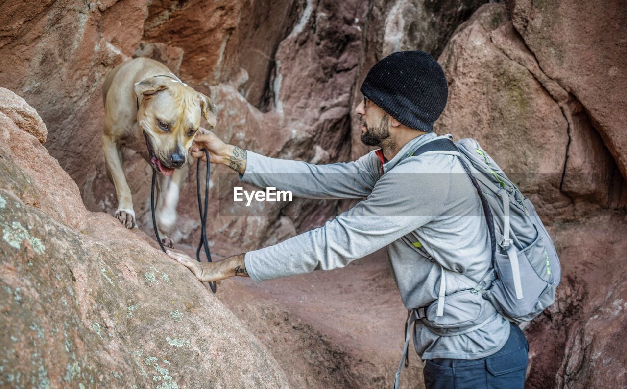 Hiker with dog on rocks