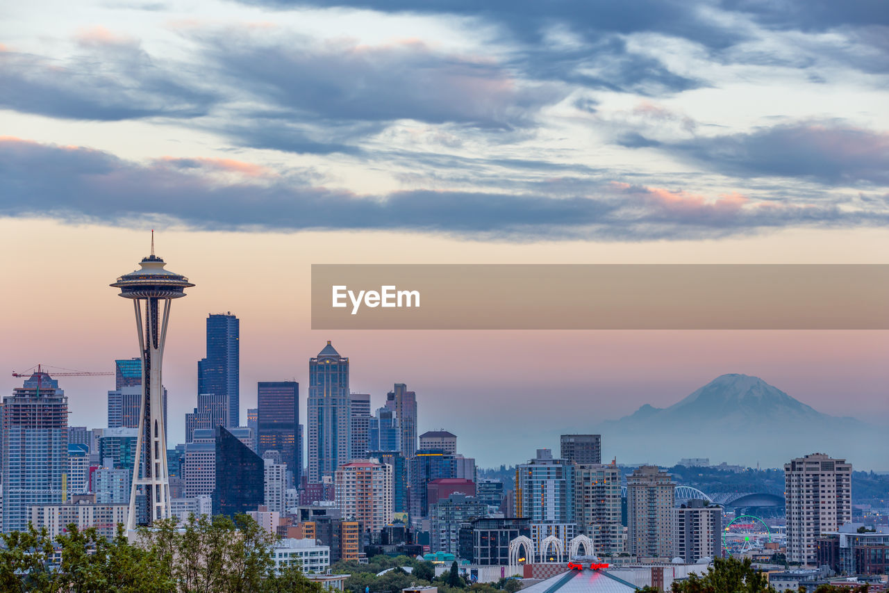 View of cityscape against cloudy sky