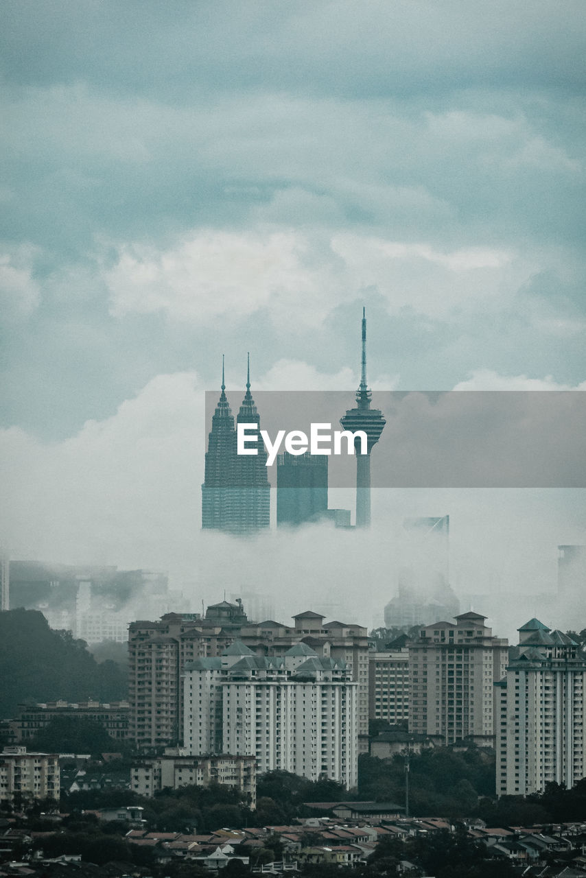 Cityscape against cloudy sky