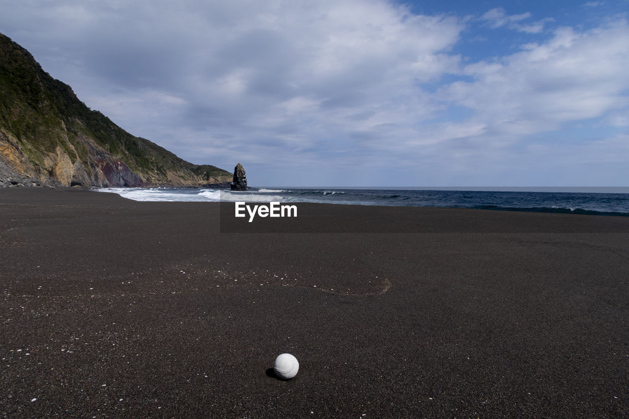 land, sea, beach, sky, water, coast, ocean, shore, cloud, scenics - nature, sand, horizon, nature, beauty in nature, body of water, coastline, environment, sports, wave, travel destinations, tranquility, no people, landscape, outdoors, tranquil scene, motion, holiday, travel, bay, horizon over water, rock, day, tourism, water's edge, seascape, non-urban scene, trip, vacation, wind wave, dramatic sky