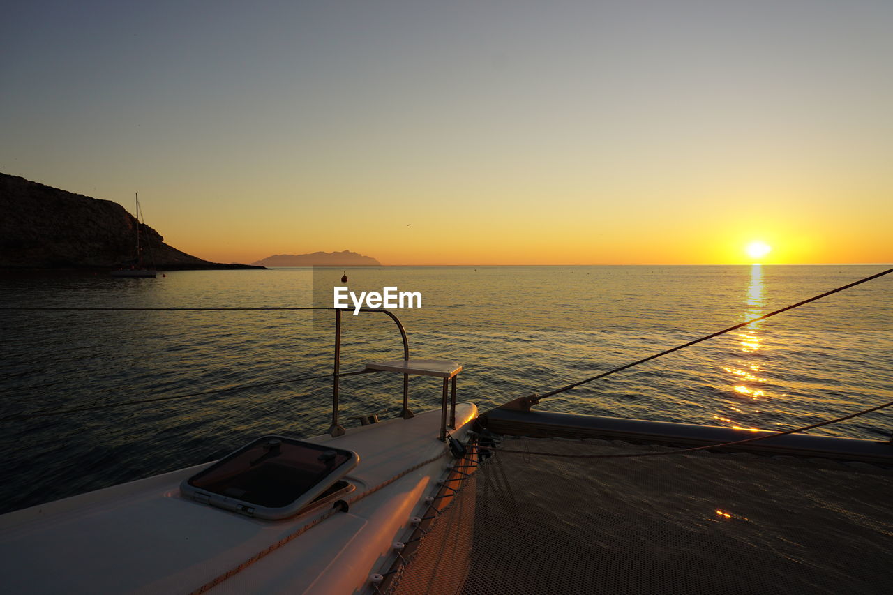 SCENIC VIEW OF SEA AGAINST ORANGE SKY