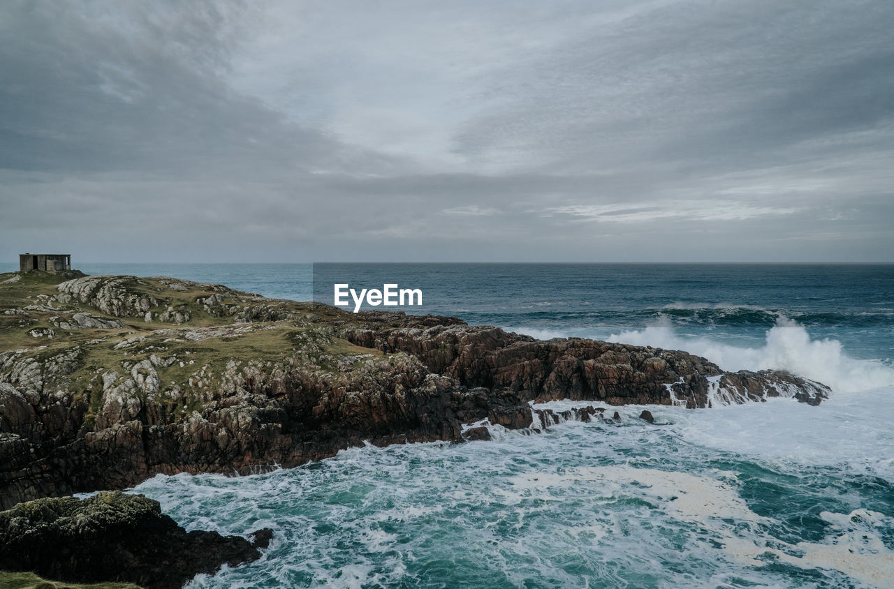 SCENIC VIEW OF SEA AND ROCKS AGAINST SKY