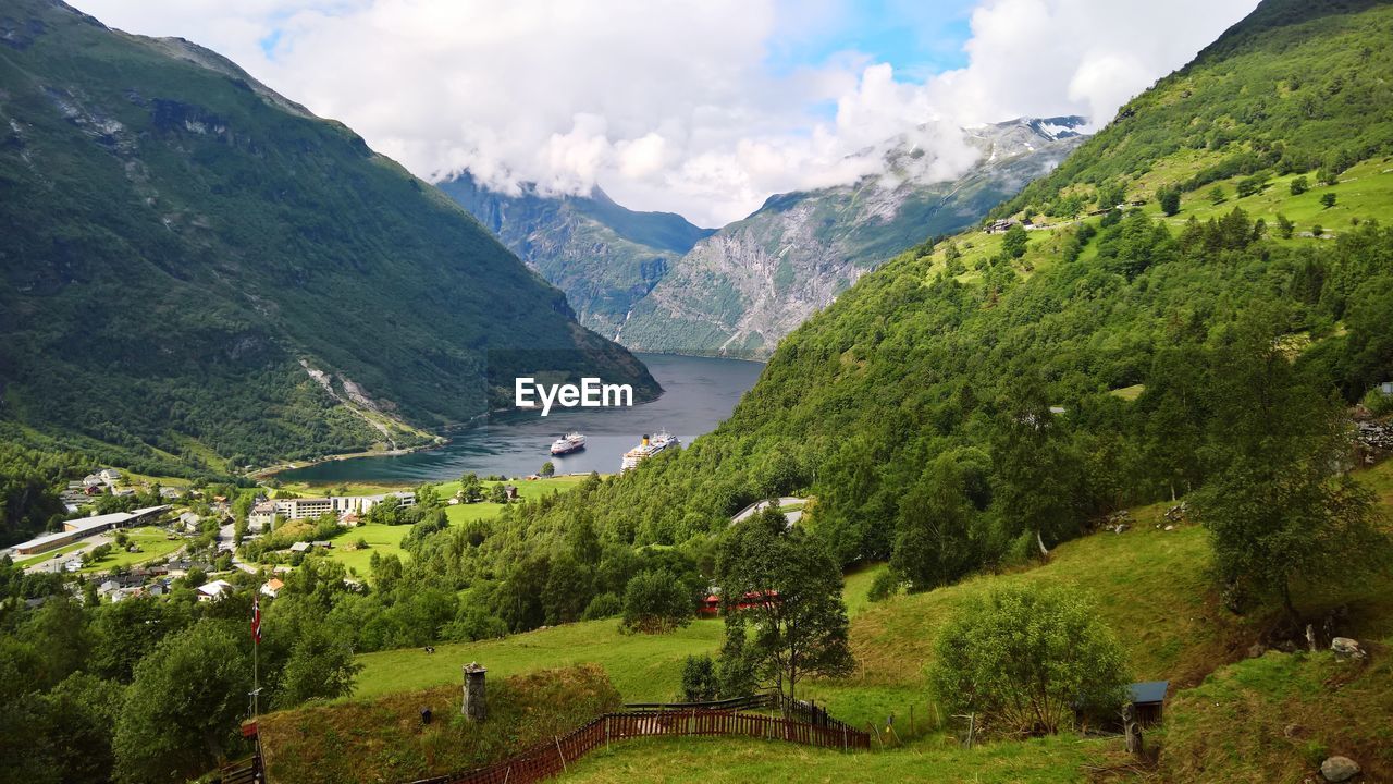 Scenic view of mountains and river against sky