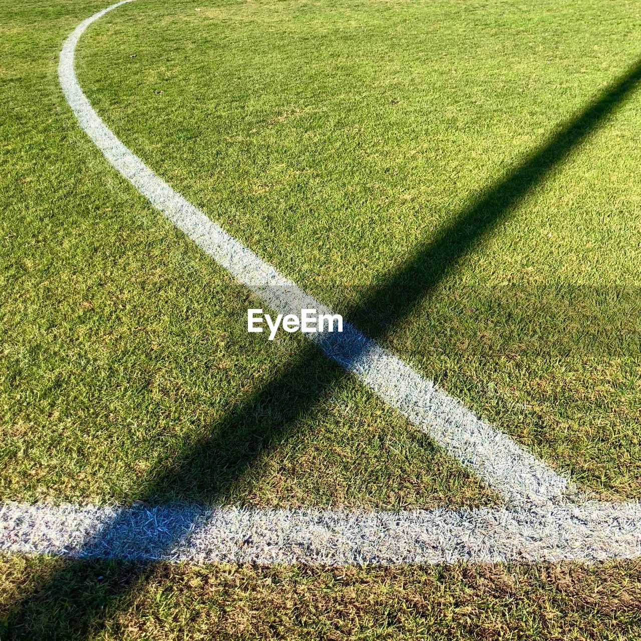 HIGH ANGLE VIEW OF SOCCER FIELD AND SHADOW ON GRASS