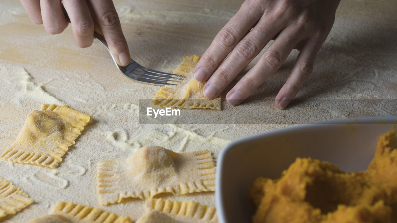 Cropped image of woman preparing food on table