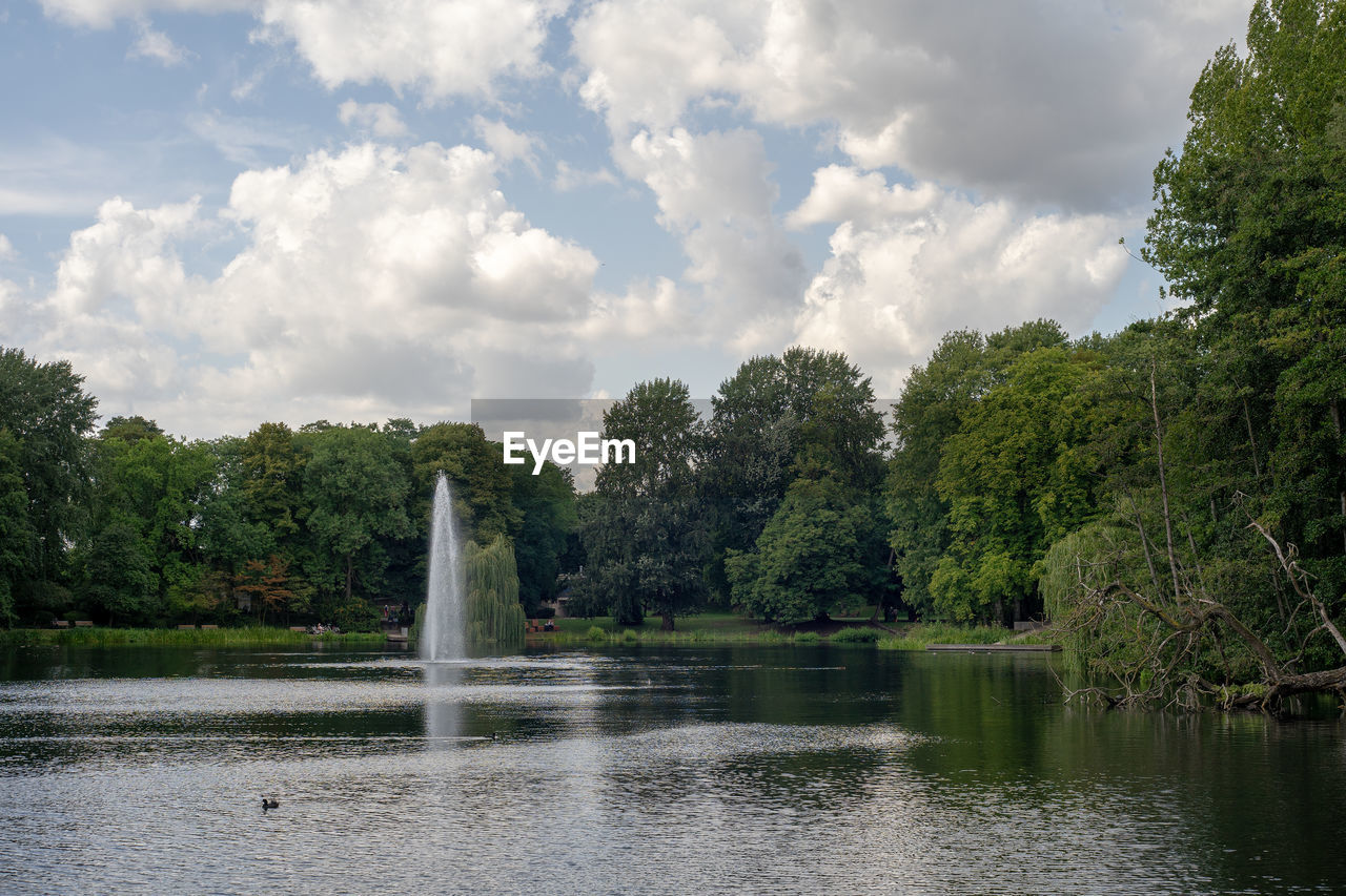 Scenic view of lake by trees against sky