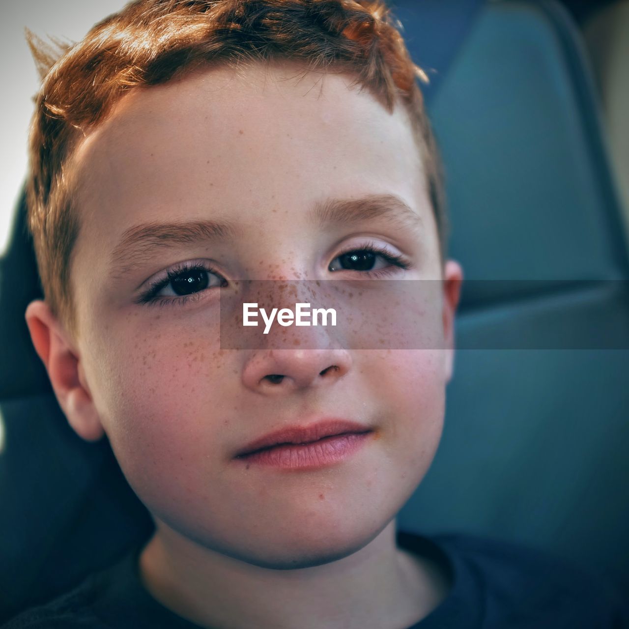 Close-up portrait of boy sitting in car