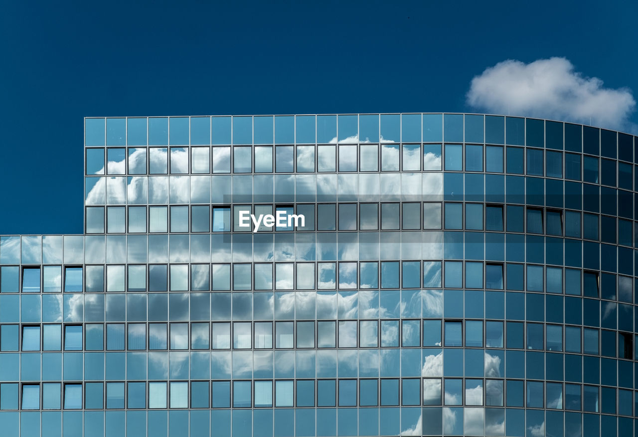 Glass modern building against sky