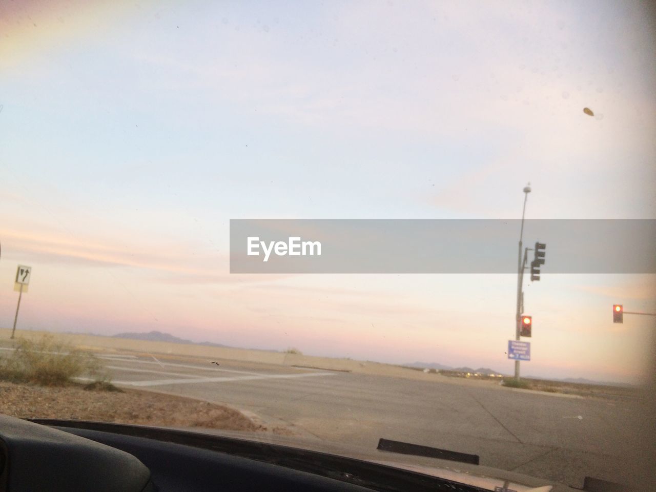 ROAD PASSING THROUGH LANDSCAPE AT SUNSET