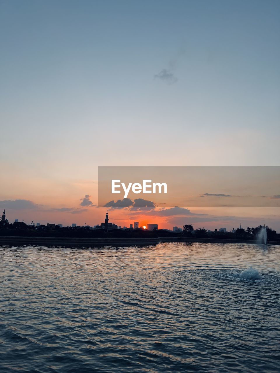 Scenic view of lake against sky during sunset 