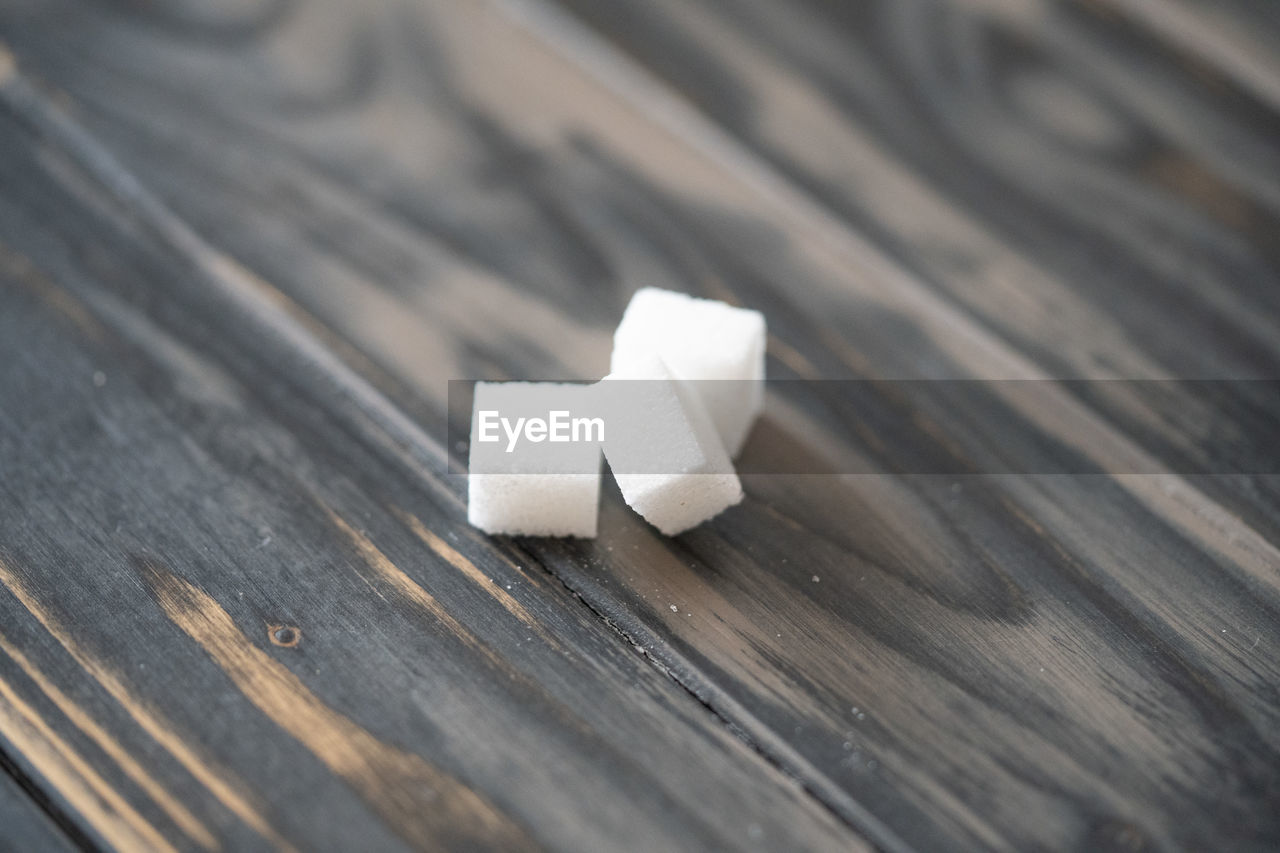 white, wood, close-up, hand, table, indoors, macro photography, still life, paper, food and drink, single object