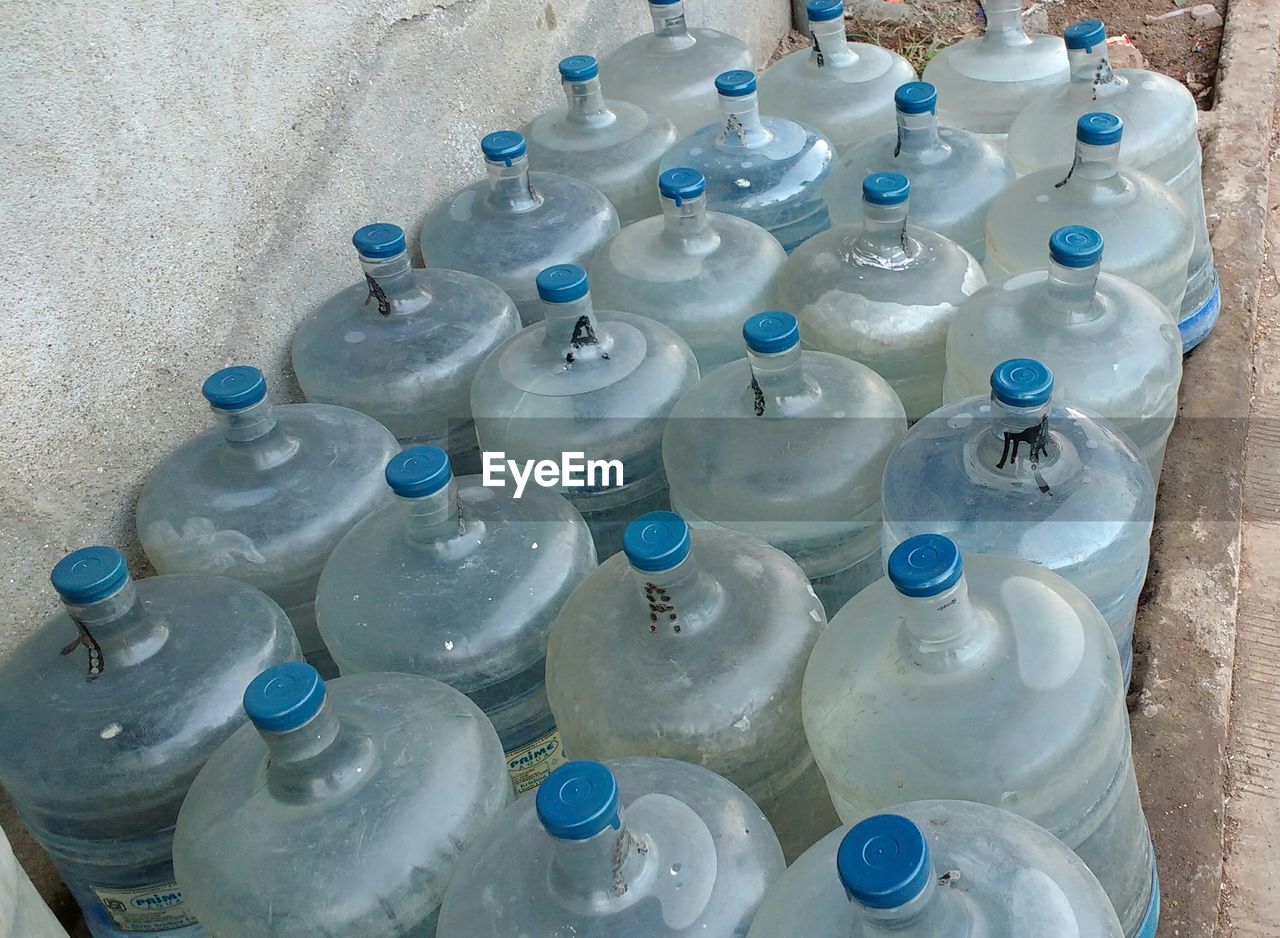 HIGH ANGLE VIEW OF BOTTLES IN PLASTIC