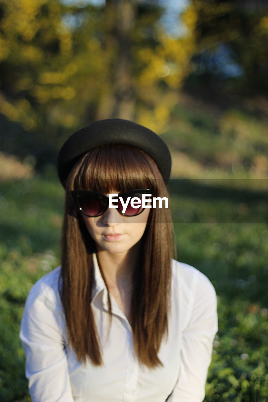 Portrait of woman wearing sunglasses standing outdoors