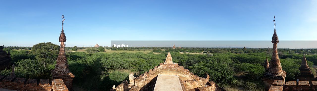 PANORAMIC VIEW OF TEMPLE AND BUILDING AGAINST SKY