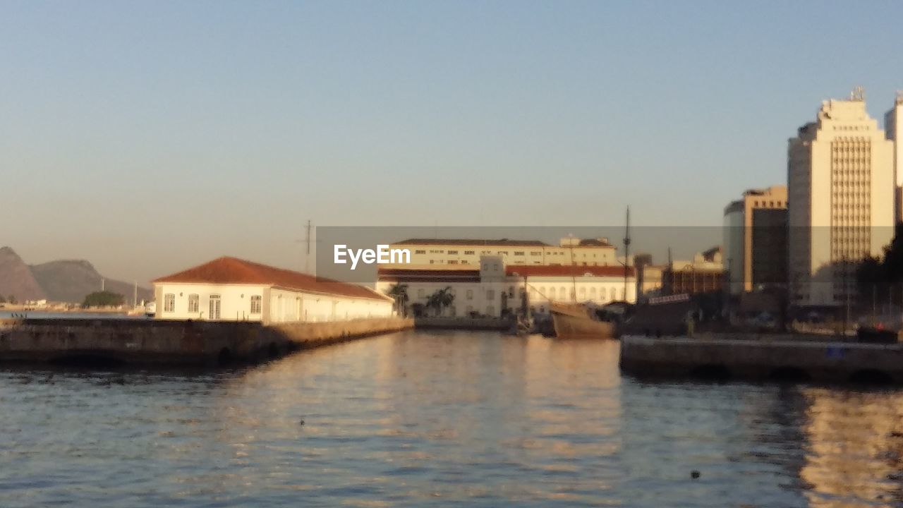 VIEW OF RIVER WITH BUILDINGS IN BACKGROUND